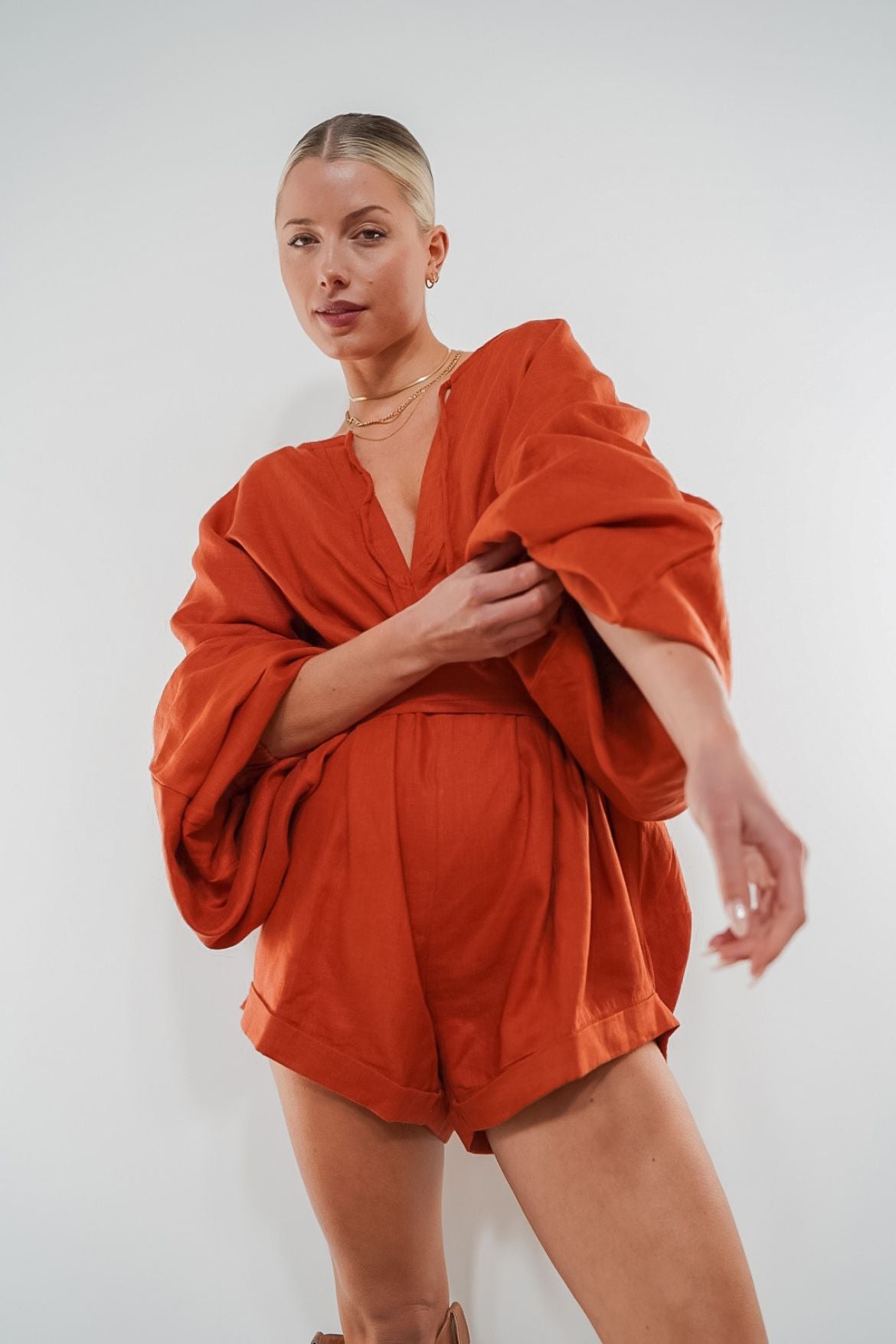 The Ease Label - Keros romper - terracotta. Linen batwing romper playsuit in an earthy orange red.