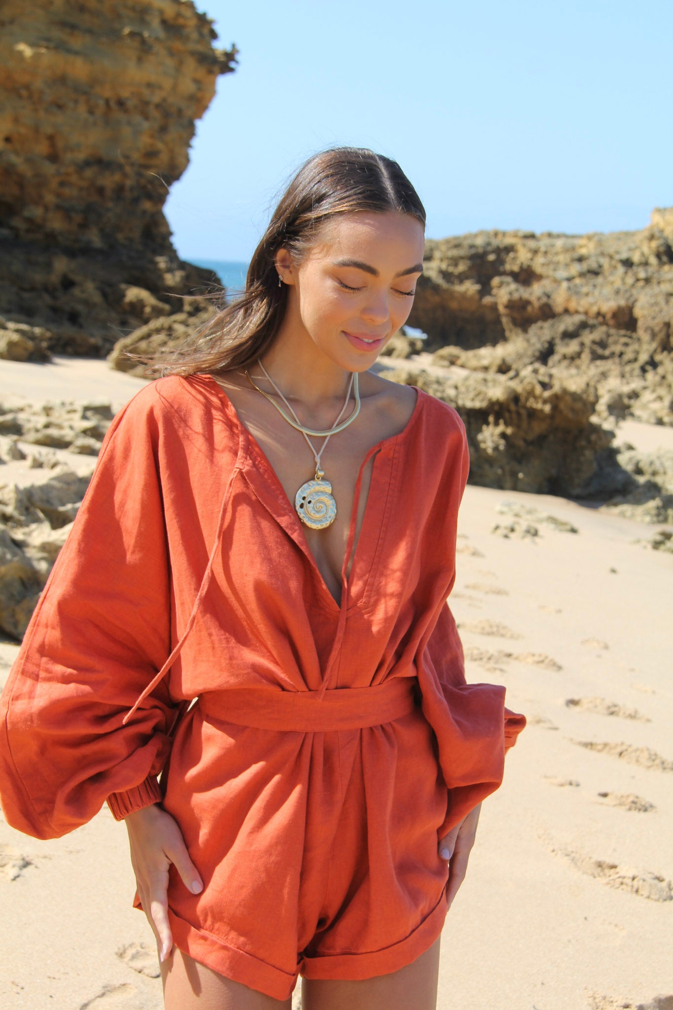 The Ease Keros Romper - Linen Batwing romper in terracotta