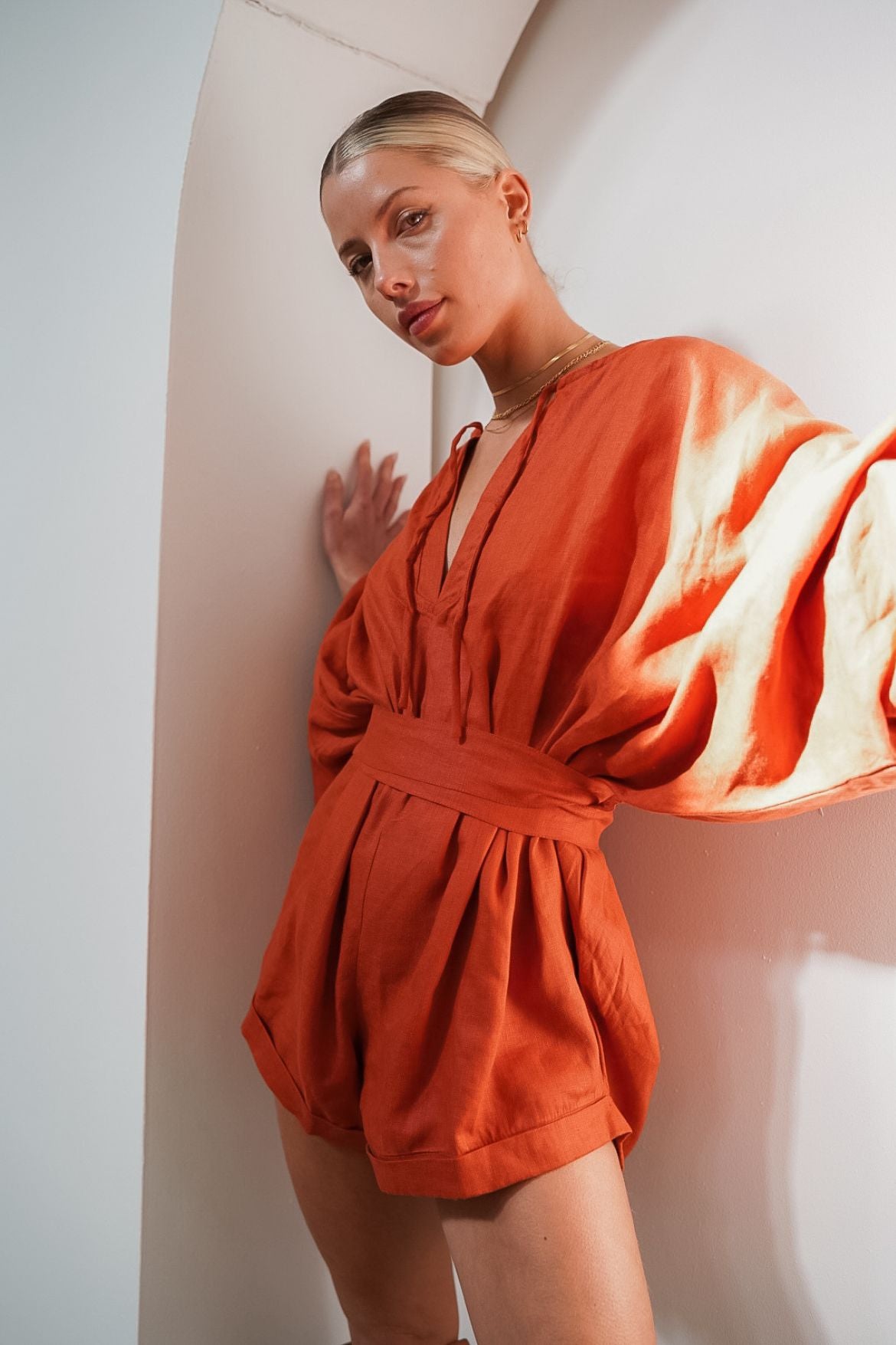 The Ease Label - Keros romper - terracotta. Linen batwing romper playsuit in an earthy orange red. 