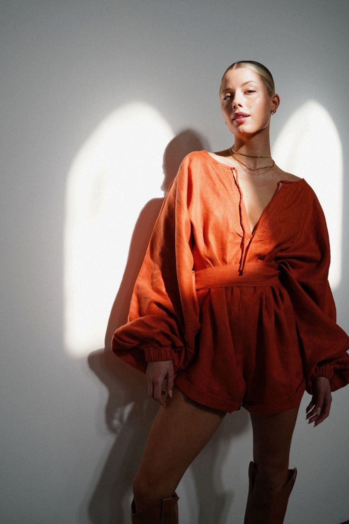 The Ease Label - Keros romper - terracotta. Linen batwing romper playsuit in an earthy orange red. 