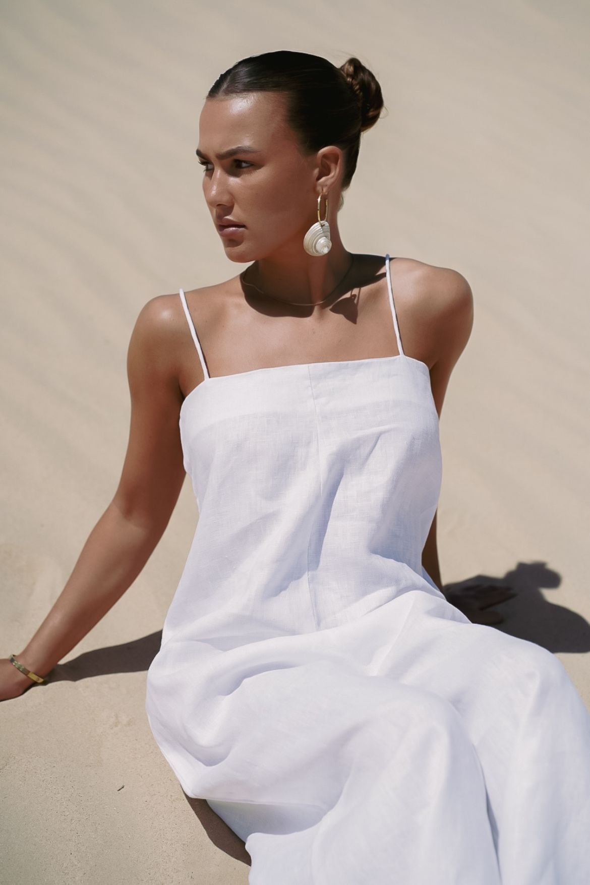 The Ease Iris Jumpsuit - White linen jumpsuit with spaghetti straps to hang off the body