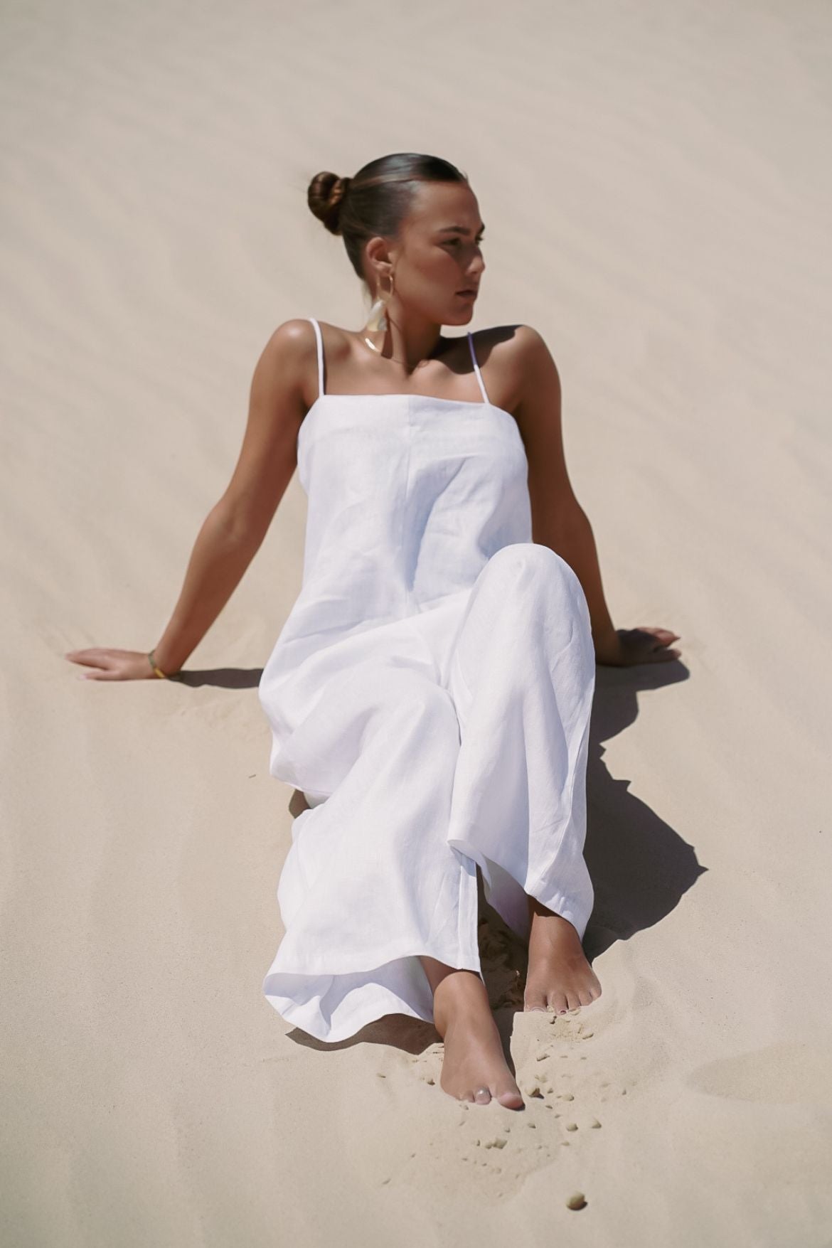 The Ease Iris Jumpsuit - White linen jumpsuit with spaghetti straps to hang off the body