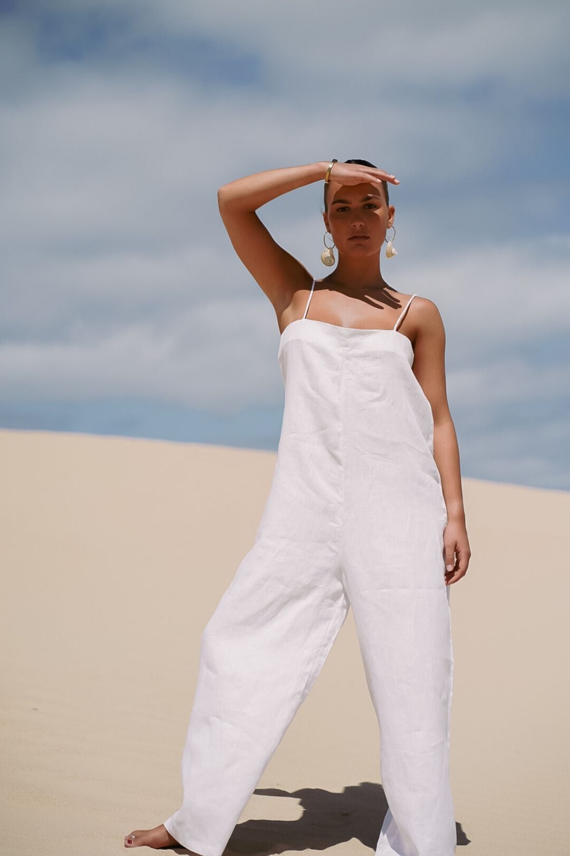 The Ease Iris Jumpsuit - White linen jumpsuit with spaghetti straps to hang off the body