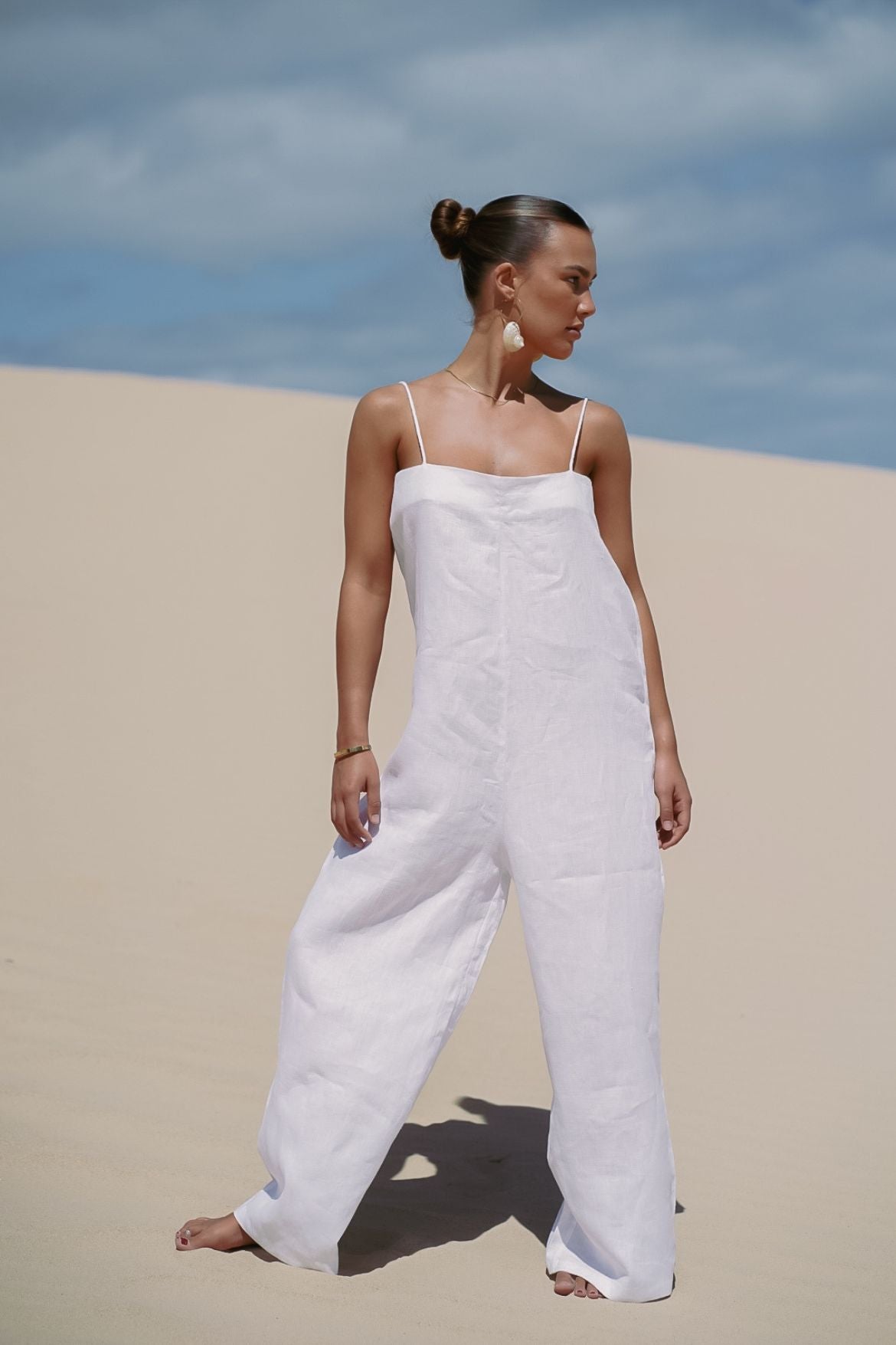 The Ease Iris Jumpsuit - White linen jumpsuit with spaghetti straps to hang off the body