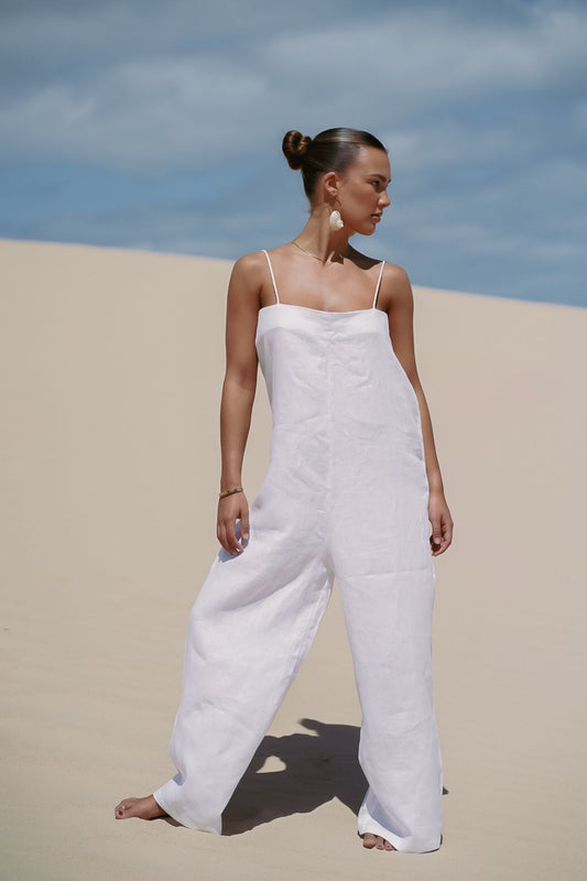 The Ease Iris Jumpsuit - White linen jumpsuit with spaghetti straps to hang off the body