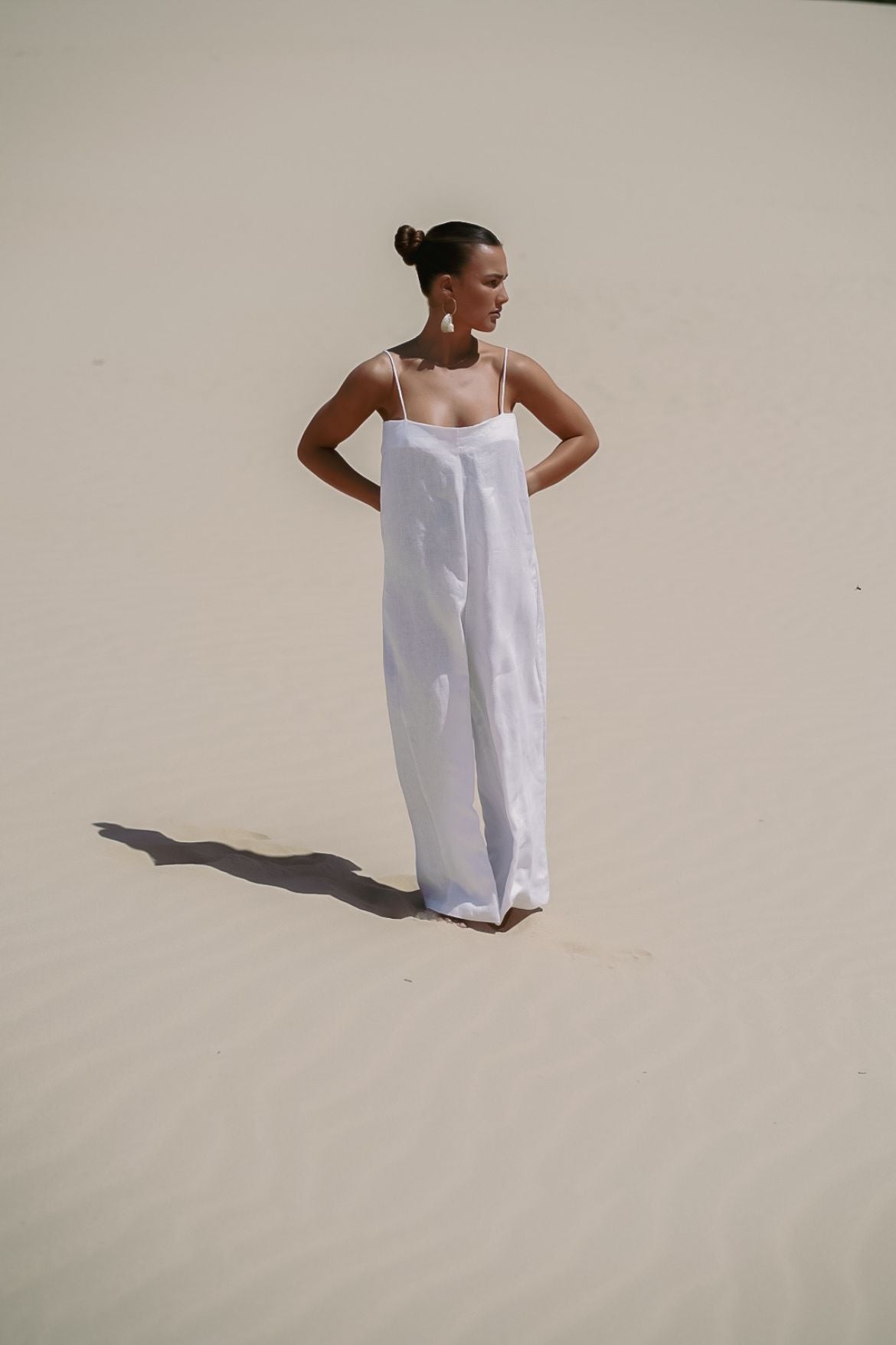 The Ease Iris Jumpsuit - White linen jumpsuit with spaghetti straps to hang off the body