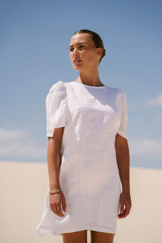 The Ease Florence Mini Dress - White linen mini dress with exaggerated sleeve and tie back