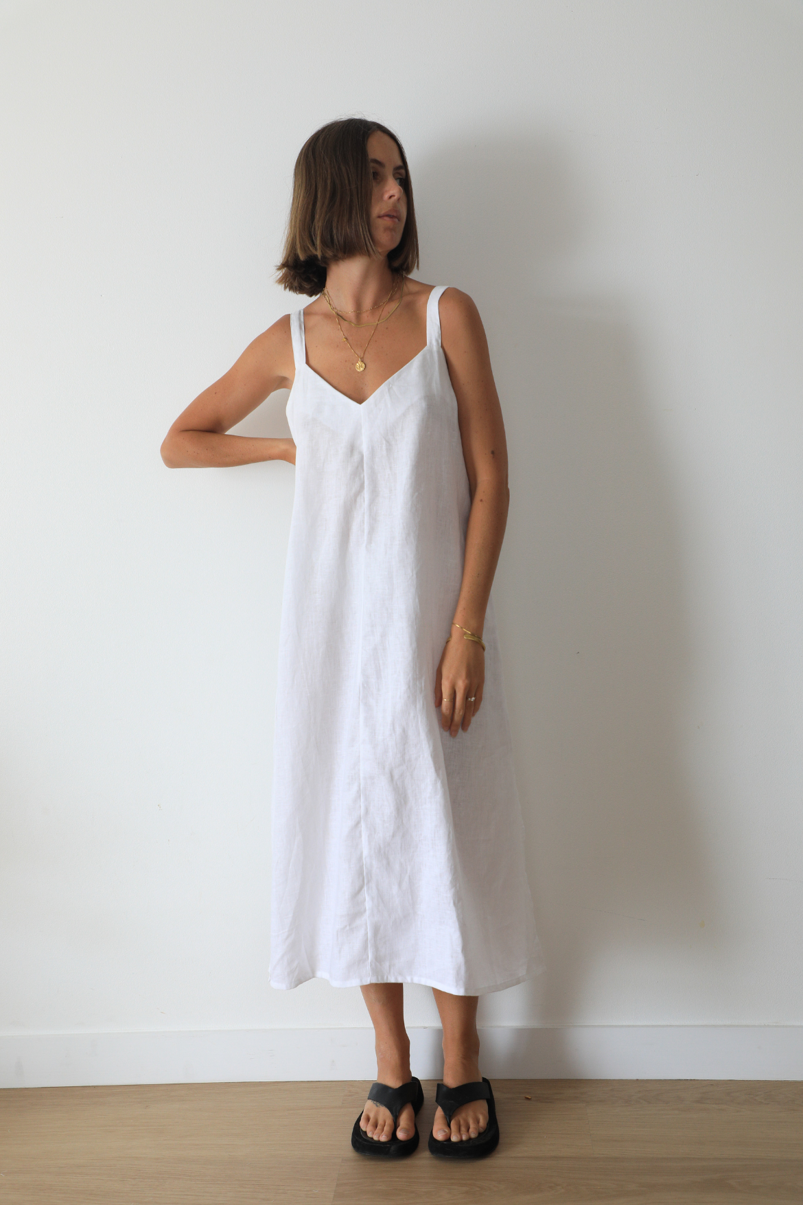 The Ease Imogen dress - Classic white linen shift dress with V neckline and leg splits