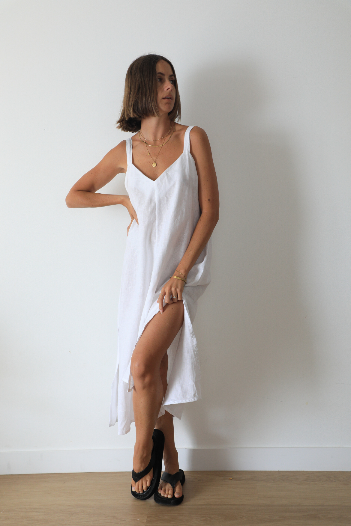 The Ease Imogen dress - Classic white linen shift dress with V neckline and leg splits