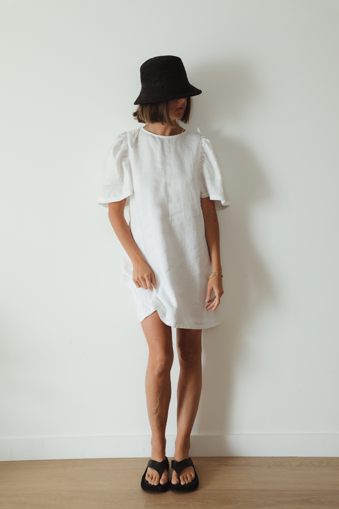 The Ease Florence Mini Dress - White linen mini dress with exaggerated sleeve and tie back