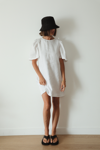 The Ease Florence Mini Dress - White linen mini dress with exaggerated sleeve and tie back