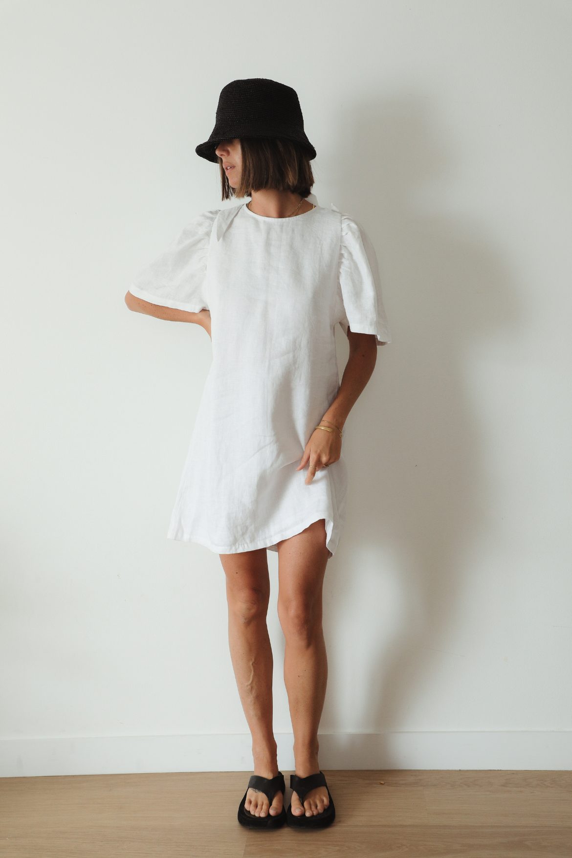 The Ease Florence Mini Dress - White linen mini dress with exaggerated sleeve and tie back