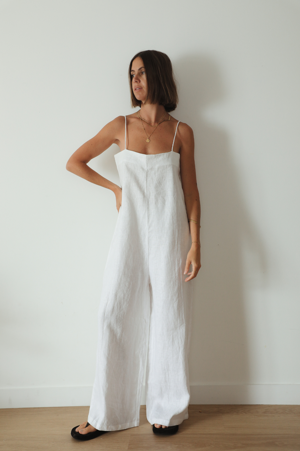 The Ease Iris Jumpsuit - White linen jumpsuit with spaghetti straps, loose fit design with long leg