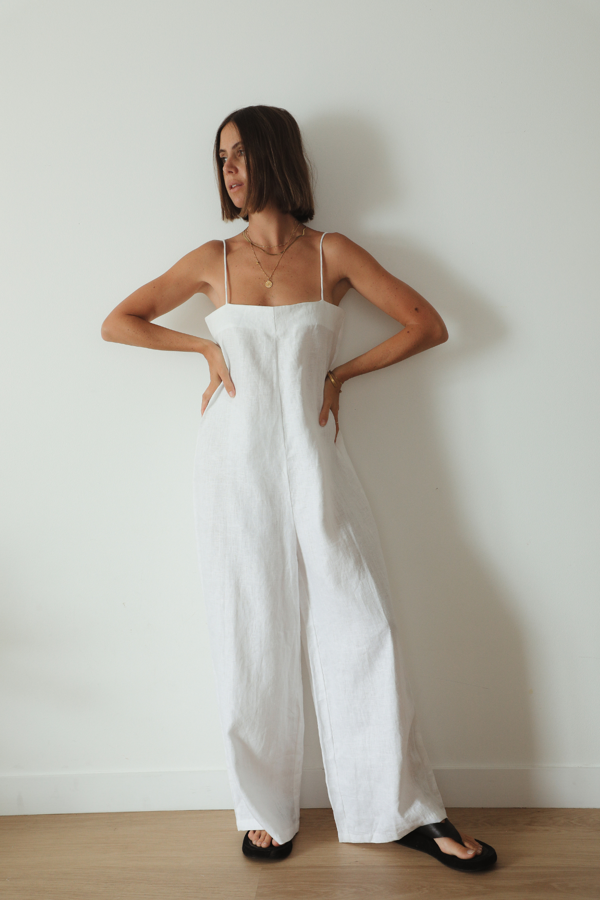 The Ease Iris Jumpsuit - White linen jumpsuit with spaghetti straps, loose fit design with long leg