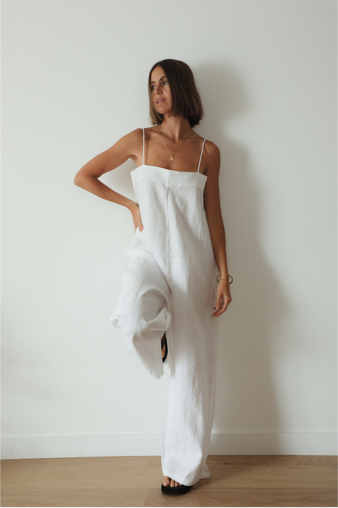 The Ease Iris Jumpsuit - White linen jumpsuit with spaghetti straps, loose fit design with long leg